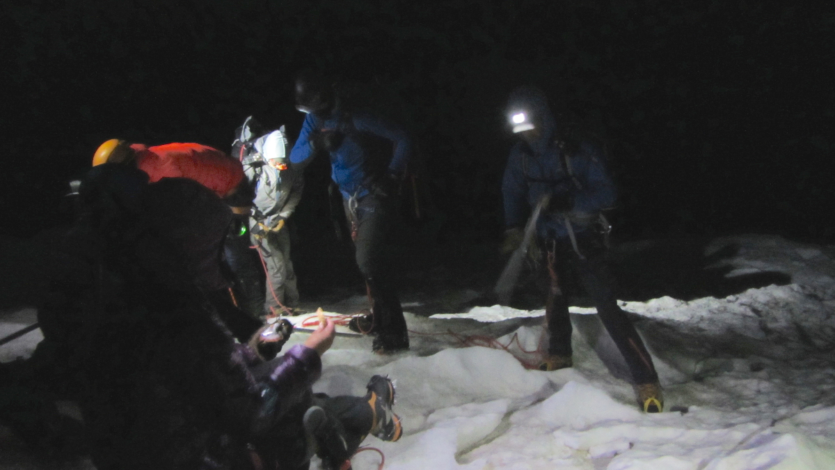 Night photo of the team preparing for summit