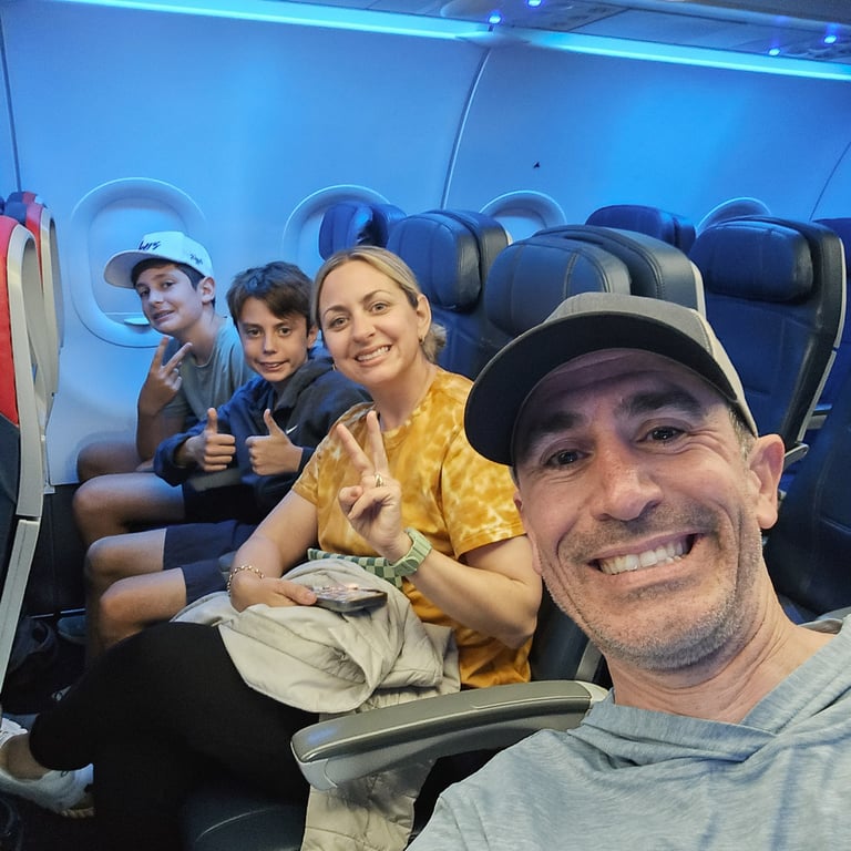 A selfie of the family on the plane to Europe (BEFORE)