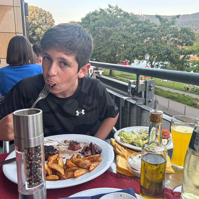 Tyler mid bite on steak