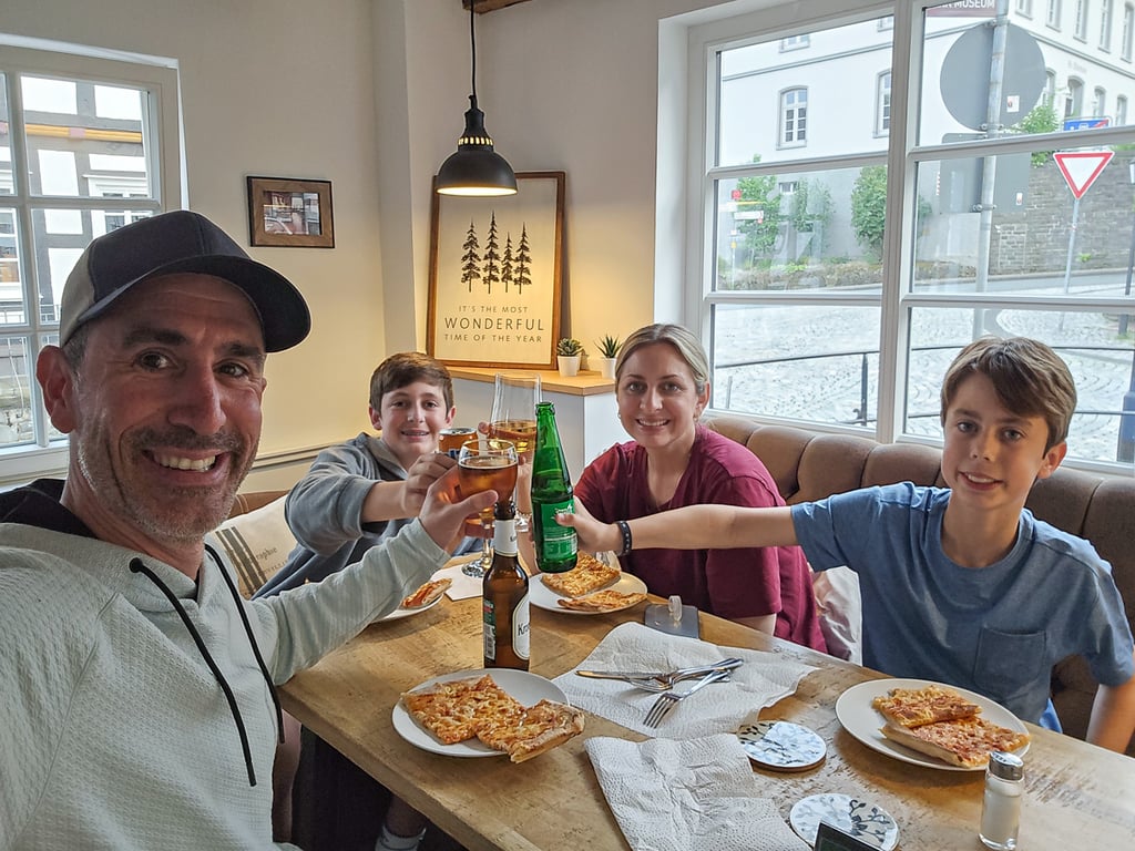 Selfie of the family enjoying pizza